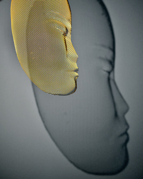 Side view of Arturo Álvarez illuminated mesh mask wall sculpture – handcrafted metallic mesh revealing sculptural depth, translucent texture and light