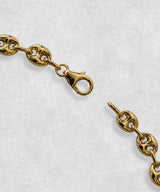 Close-up of gold coffee bean bracelet clasp – polished coffee bean links and detailed fastening mechanism