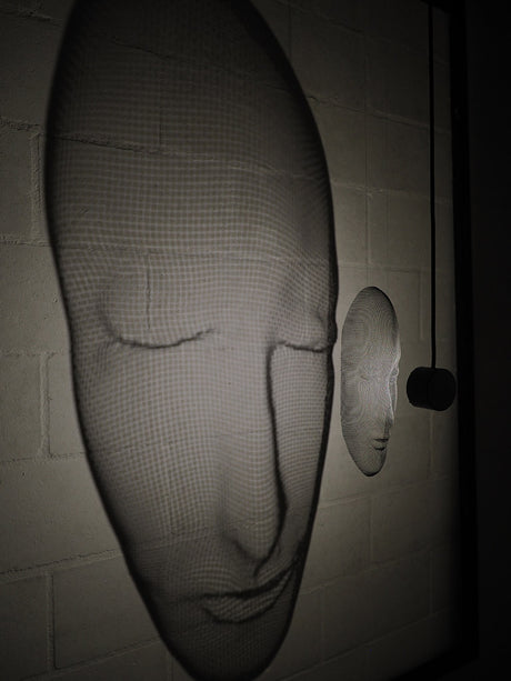 Arturo Álvarez illuminated mesh mask wall sculpture – handcrafted metallic mesh revealing sculptural depth, translucent texture and light