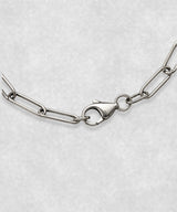 Close-up of 925 sterling silver paperclip bracelet clasp – polished elongated link chain detail