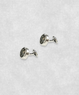 Side view of chrome-plated tourbillon cufflinks – luxury watch-inspired design with moving flywheel and blue screw details